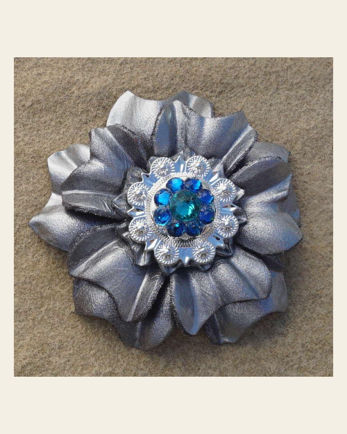 Silver Carnation Flower With Bright Silver Teal and Capri 1" Concho on a warm cream background
