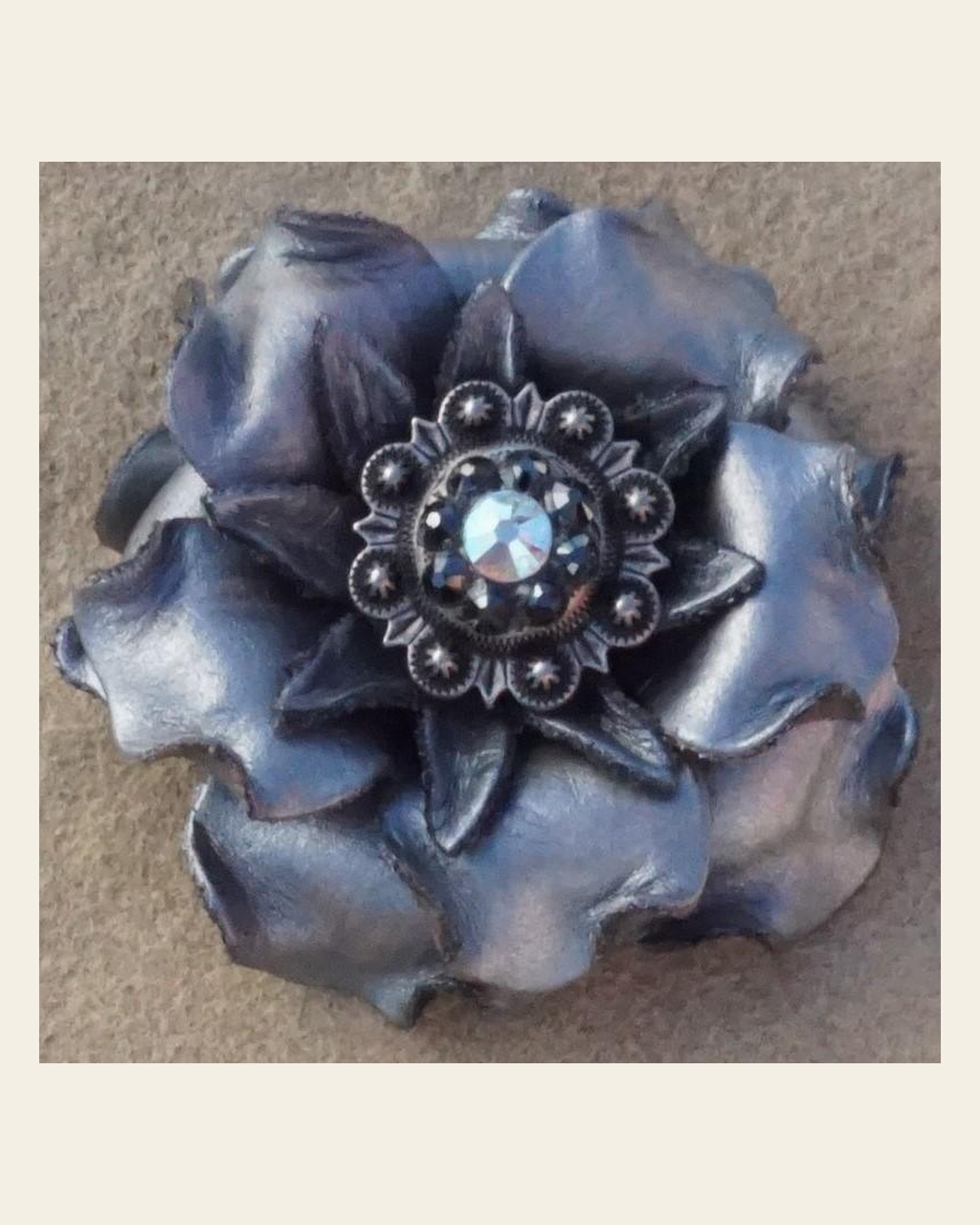 Silver Gardenia Flower With Antique Silver Jet & AB 1" Concho on a warm cream background