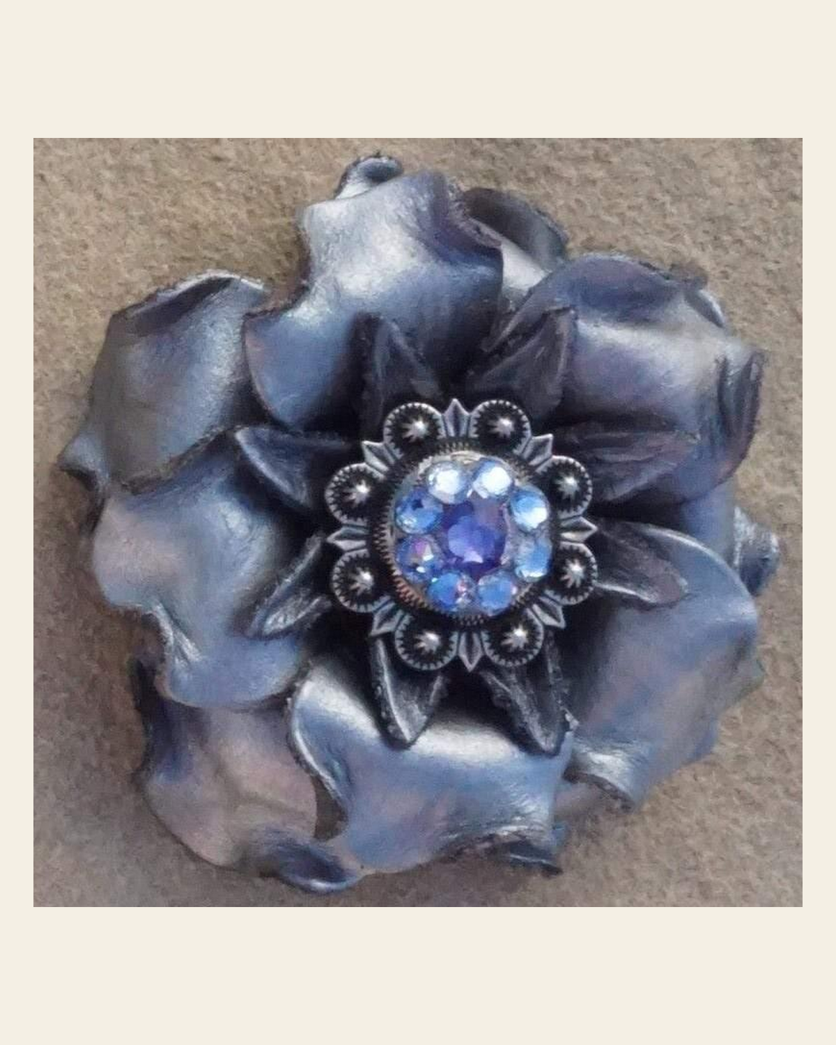 Silver Gardenia Flower With Antique Silver Light Sapphire & Lilac 1" Concho on a warm cream background