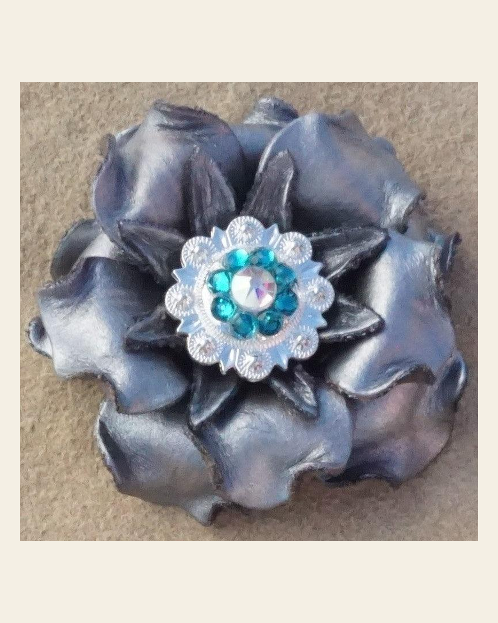 Silver Gardenia Flower With Bright Silver Teal and AB 1" Concho on a warm cream background