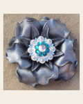 Silver Gardenia Flower With Bright Silver Teal and AB 1" Concho on a warm cream background