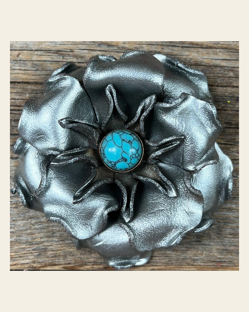 Silver Gardenia Flower With Round Turquoise Cabochon on a warm cream background