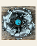 Silver Gardenia Flower With Round Turquoise Cabochon on a warm cream background