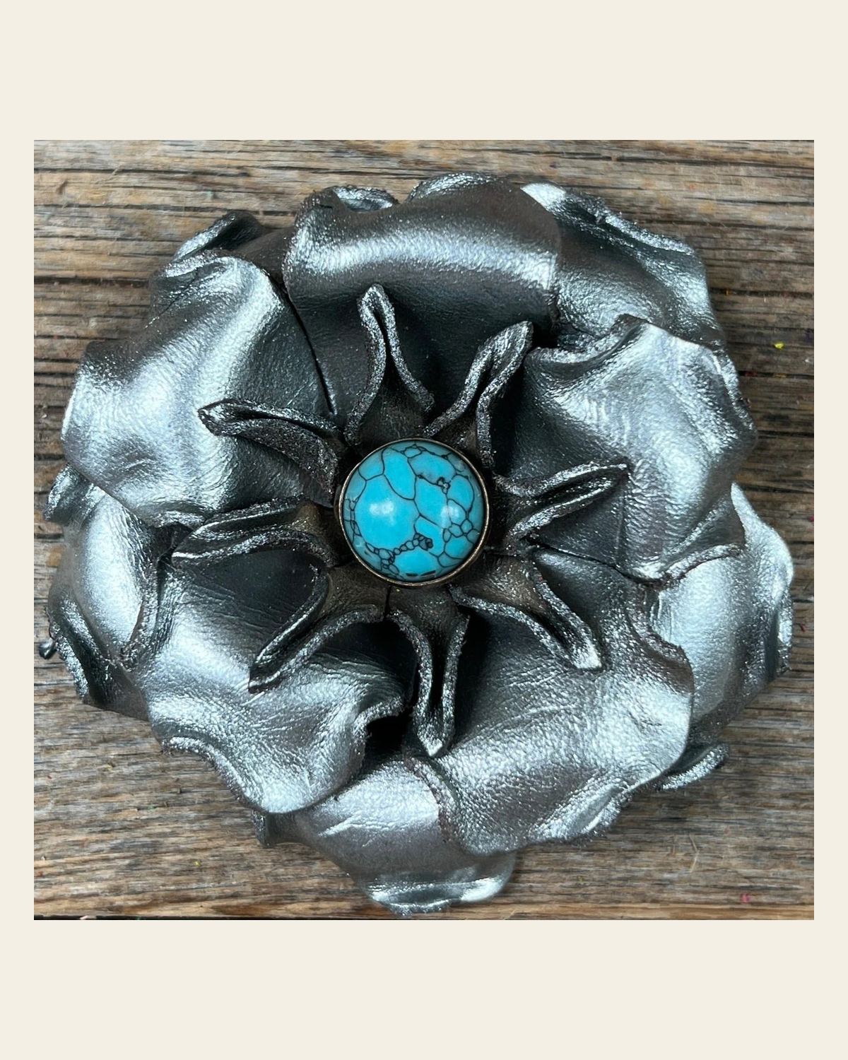 Silver Gardenia Flower With Round Turquoise Cabochon on a warm cream background