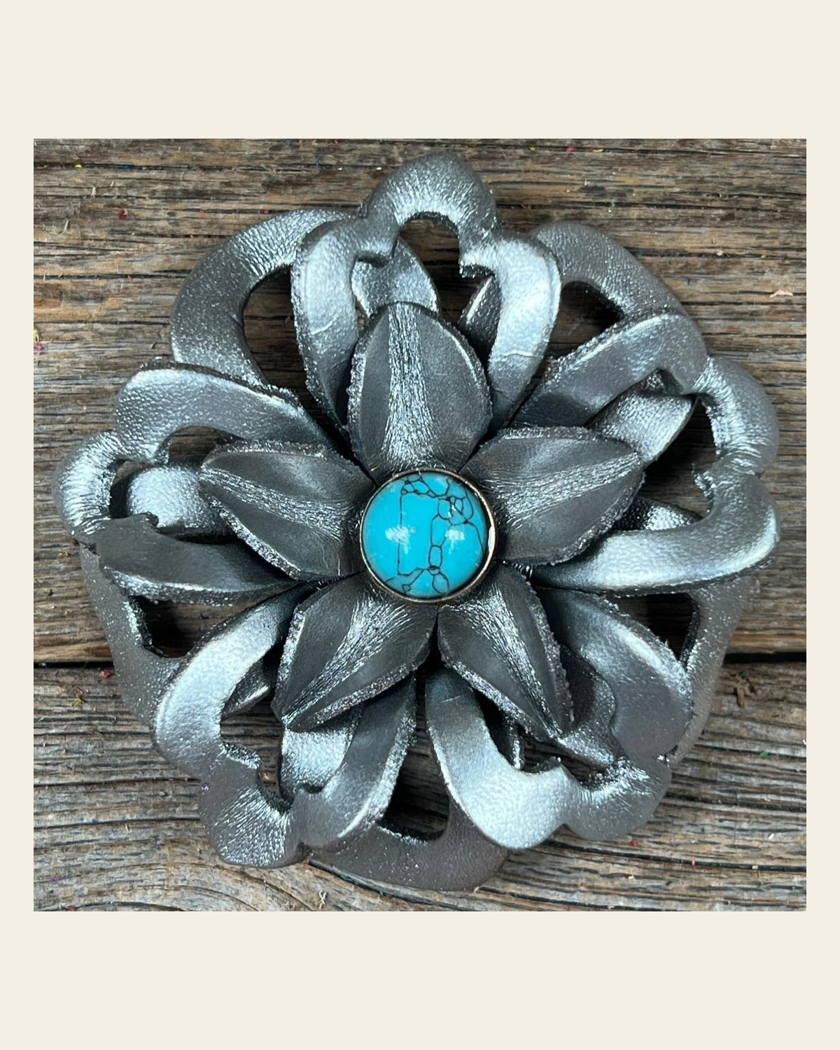 Silver Lotus Flower With Round Turquoise Cabochon on a warm cream background