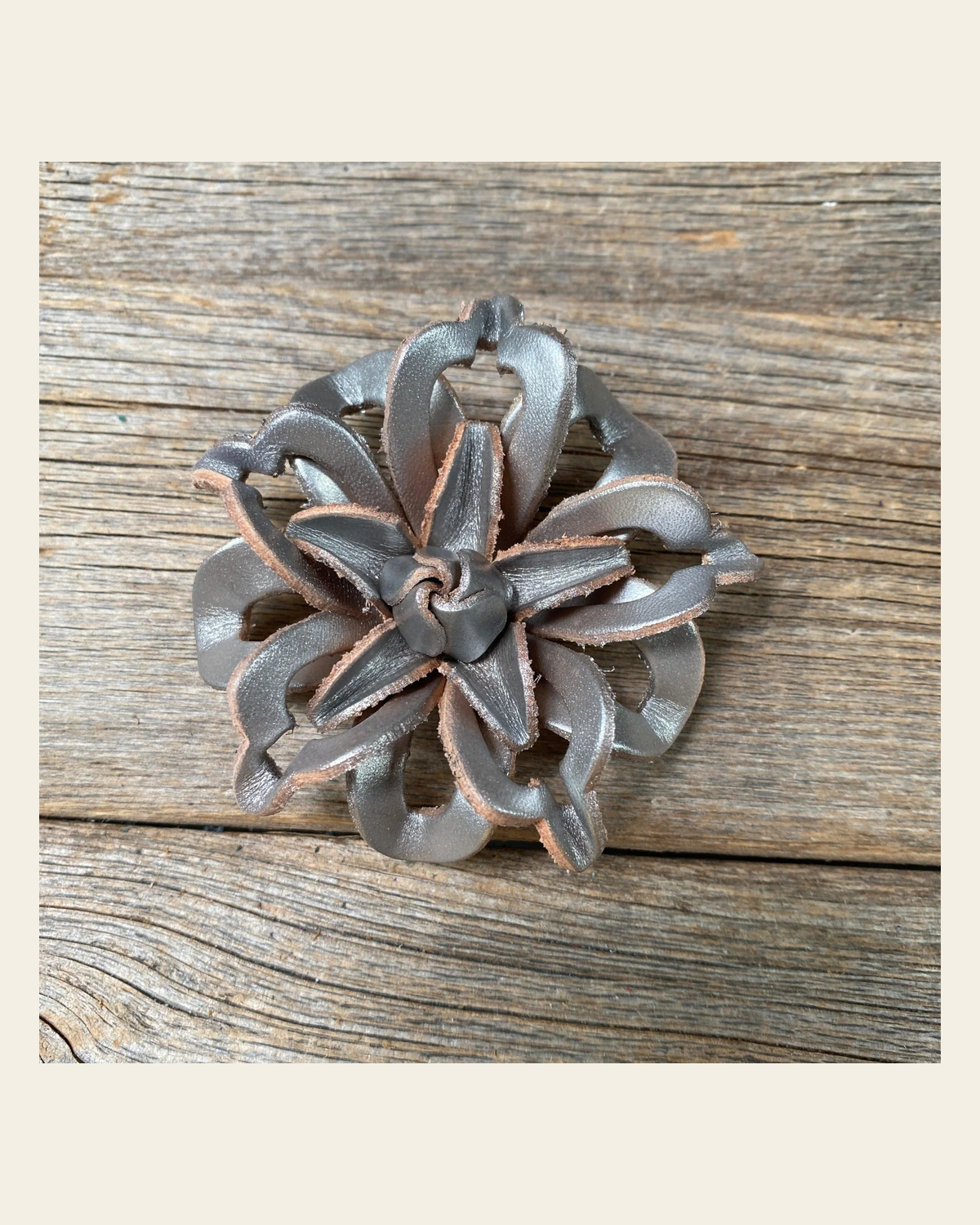 Silver Lotus Leather Flower on a warm cream background