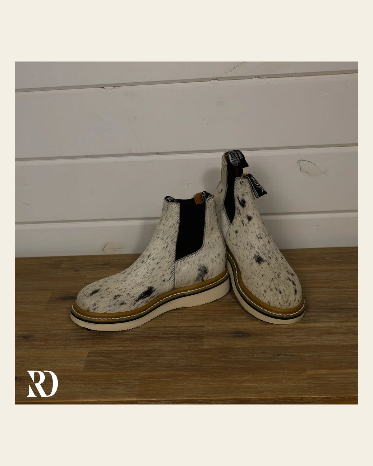 Size 7.5 (style #10) | Hair On Hide Lechera Boot on a warm cream background