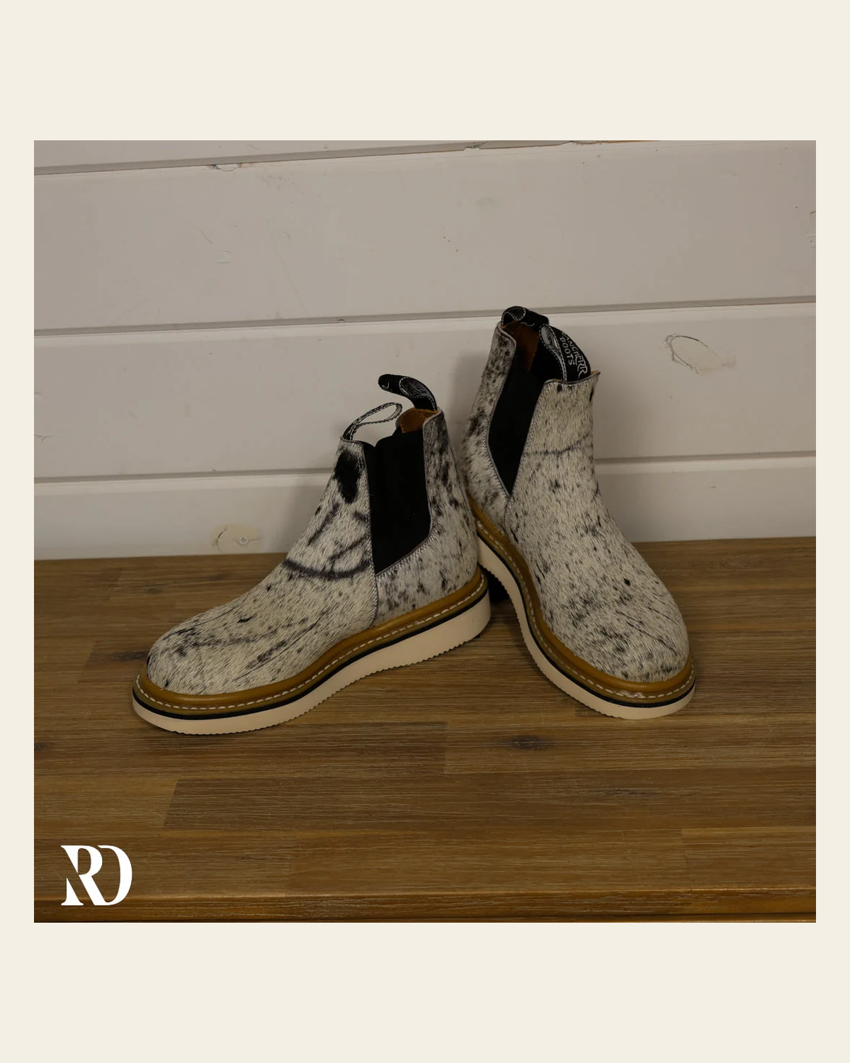 Size 7.5 (style #5) | Hair On Hide Lechera Boot *marked Hide* on a warm cream background