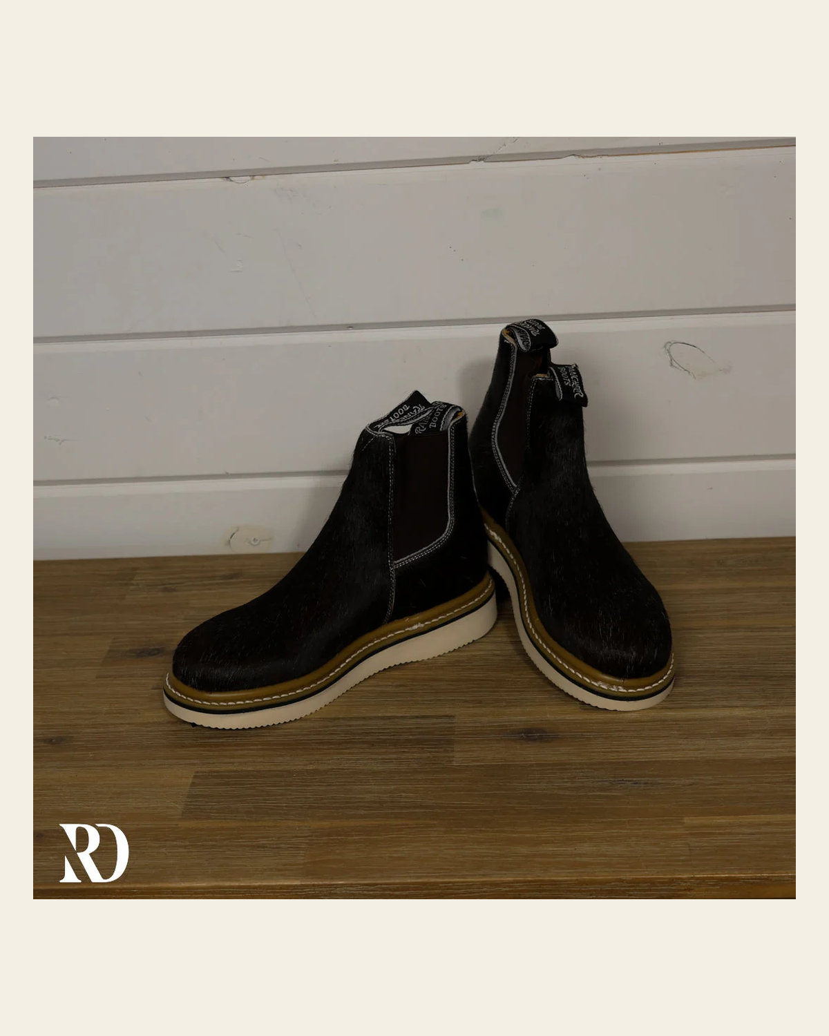 Size 7.5 (style #6) | Hair On Hide Lechera Boot on a warm cream background