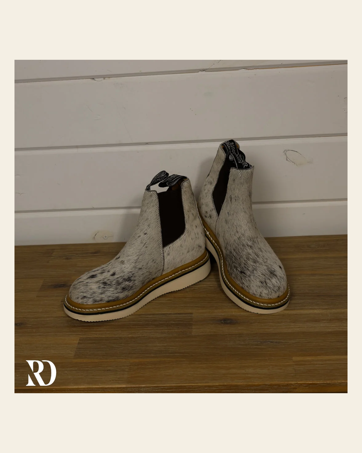 Size 7.5 (style #7) | Hair On Hide Lechera Boot on a warm cream background