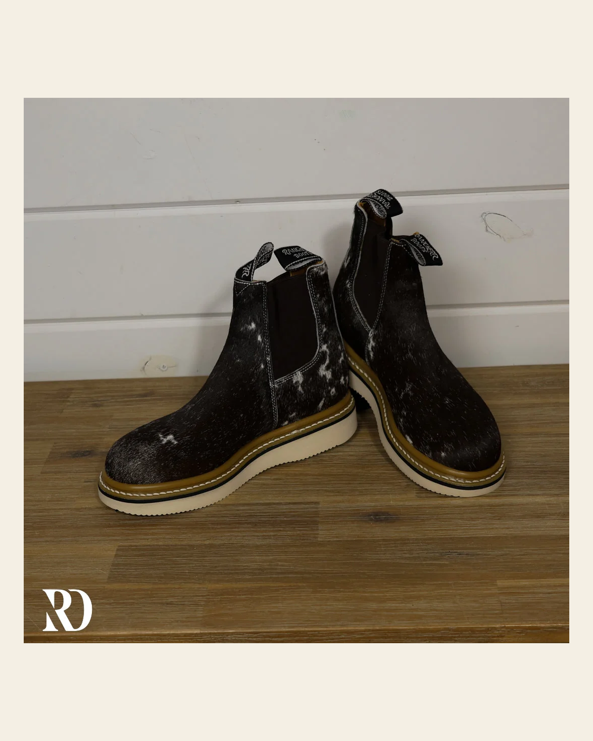 Size 7.5 (style #9) | Hair On Hide Lechera Boot on a warm cream background