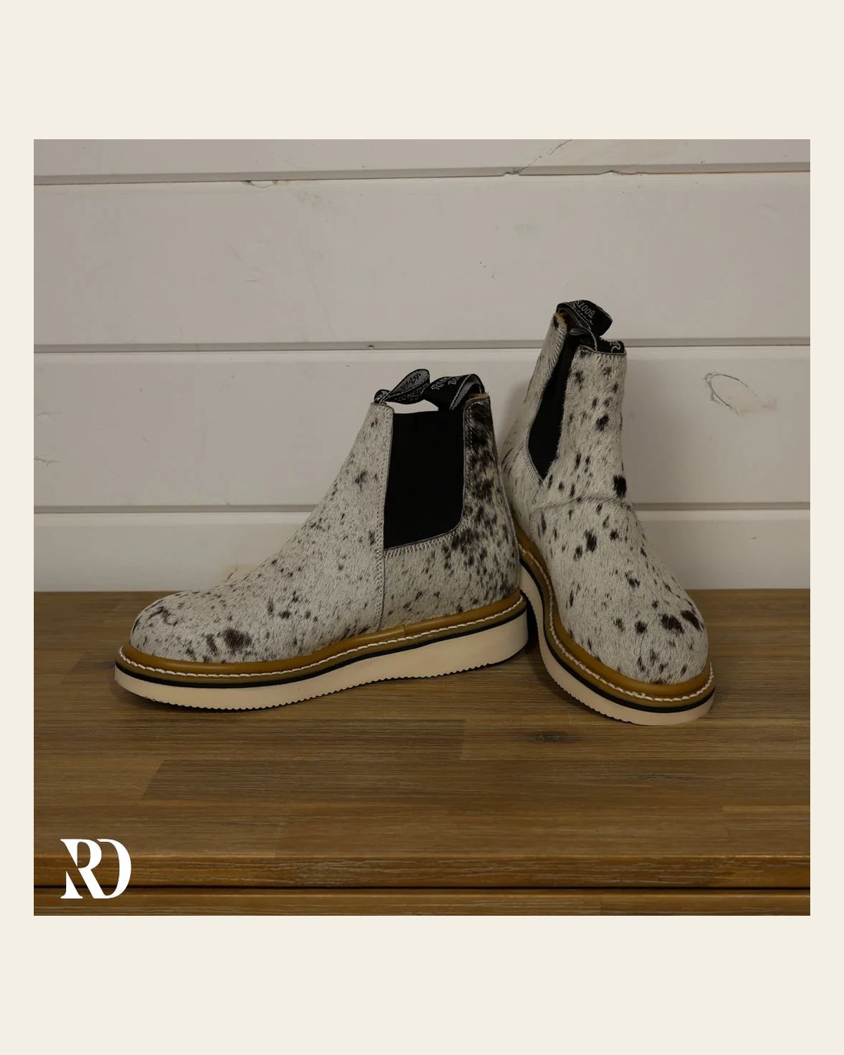 Size 7.5 (style #128) | Hair On Hide Lechera Boot on a warm cream background