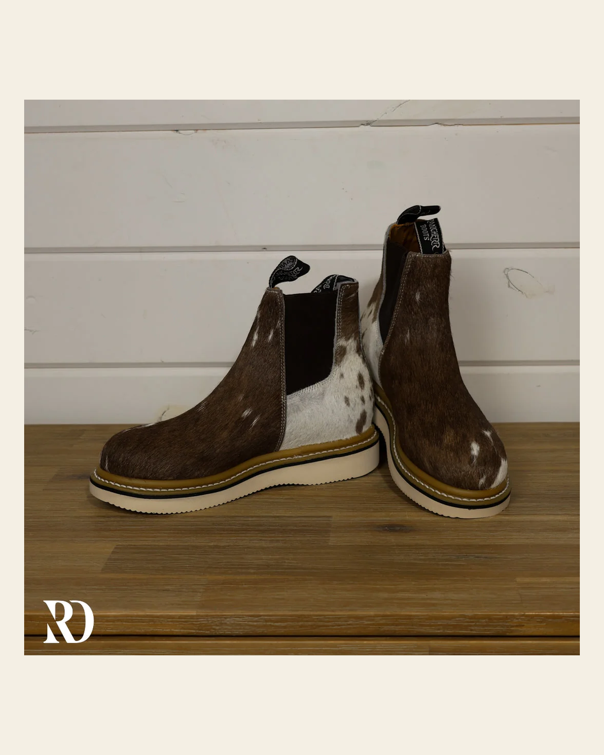 Size 7.5 (style #129) | Hair On Hide Lechera Boot on a warm cream background