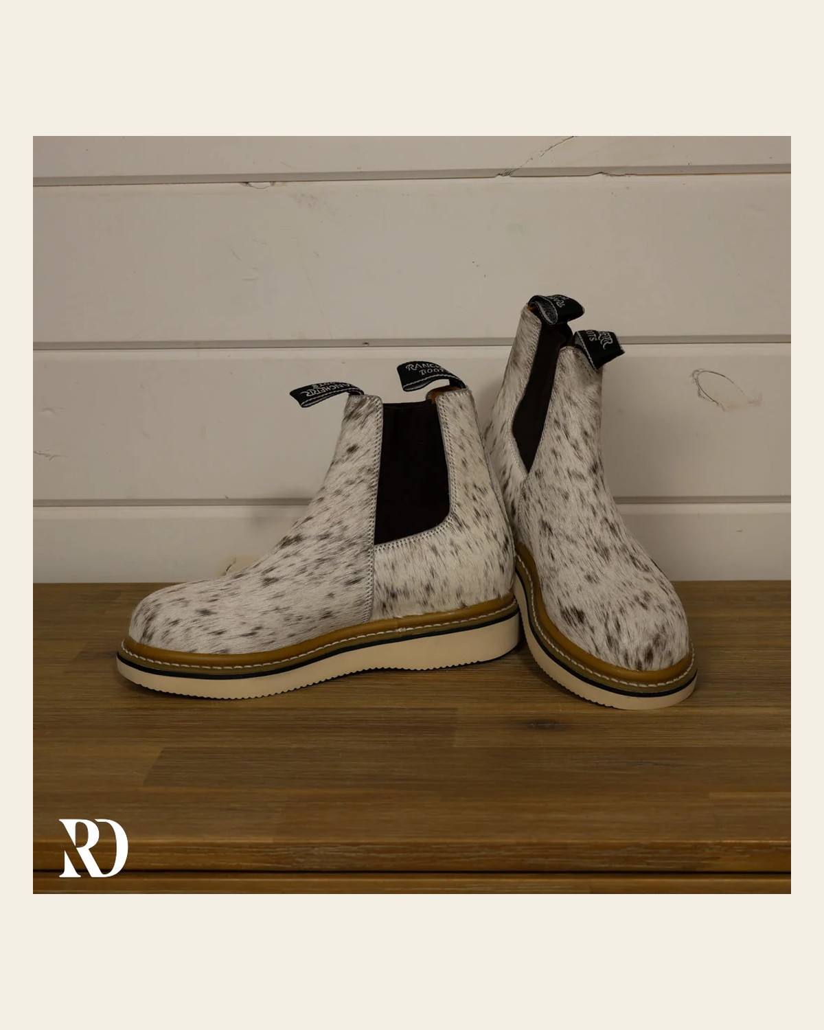 Size 7.5 (style #130) | Hair On Hide Lechera Boot on a warm cream background