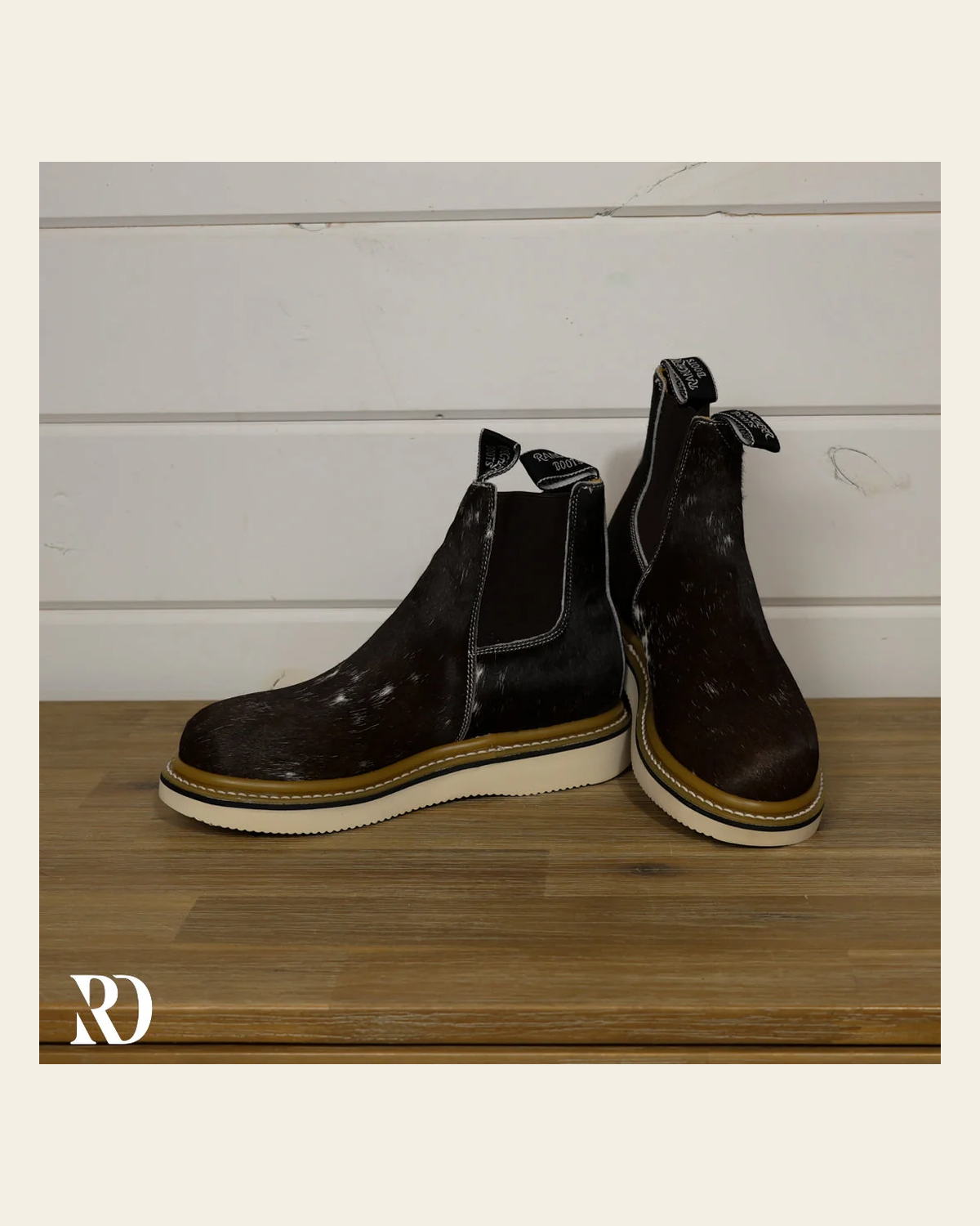 Size 7.5 (style #131) | Hair On Hide Lechera Boot on a warm cream background