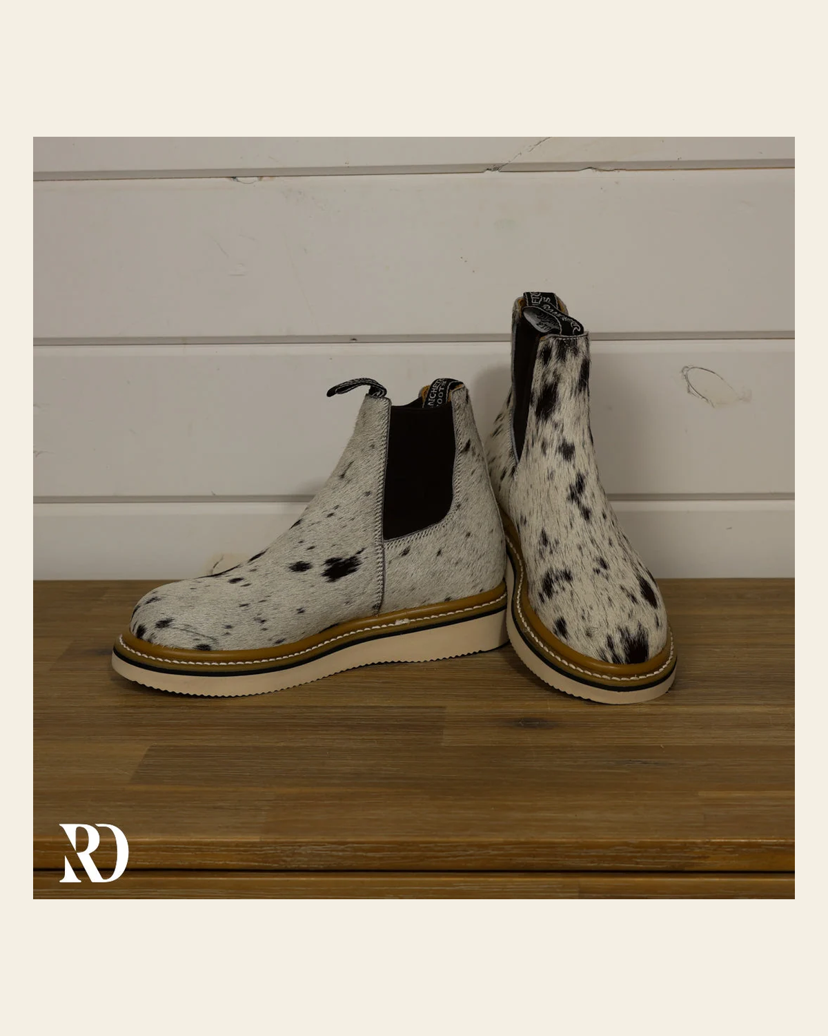 Size 7.5 (style #136) | Hair On Hide Lechera Boot on a warm cream background