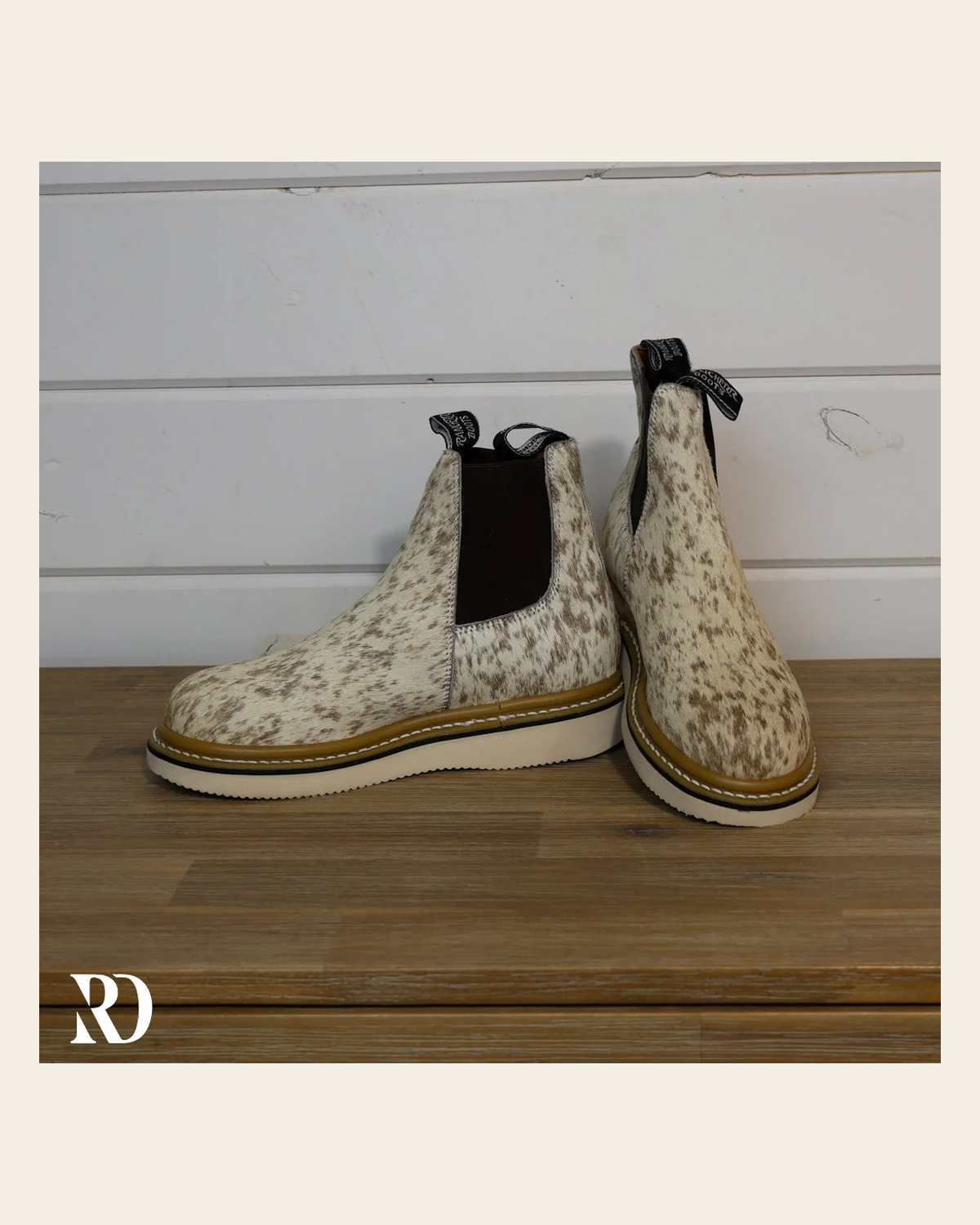 Size 7.5 (style #186) | Hair On Hide Lechera Boot on a warm cream background
