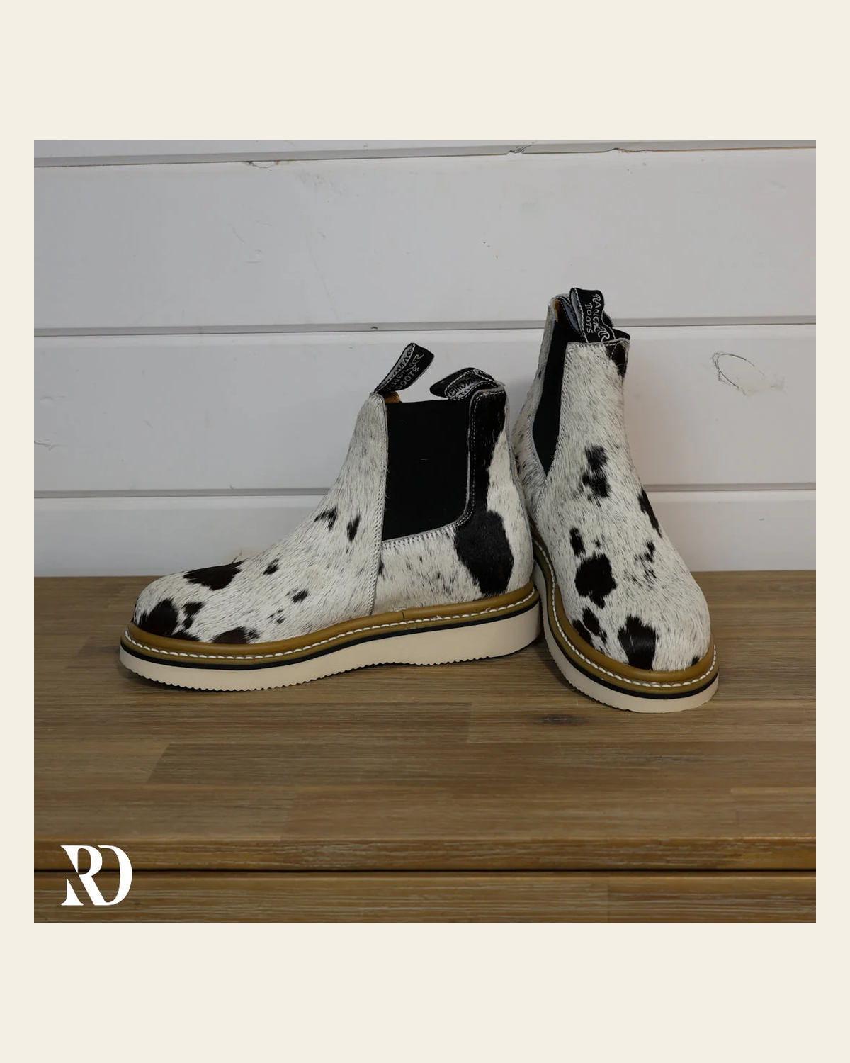 Size 7.5 (style #187) | Hair On Hide Lechera Boot on a warm cream background