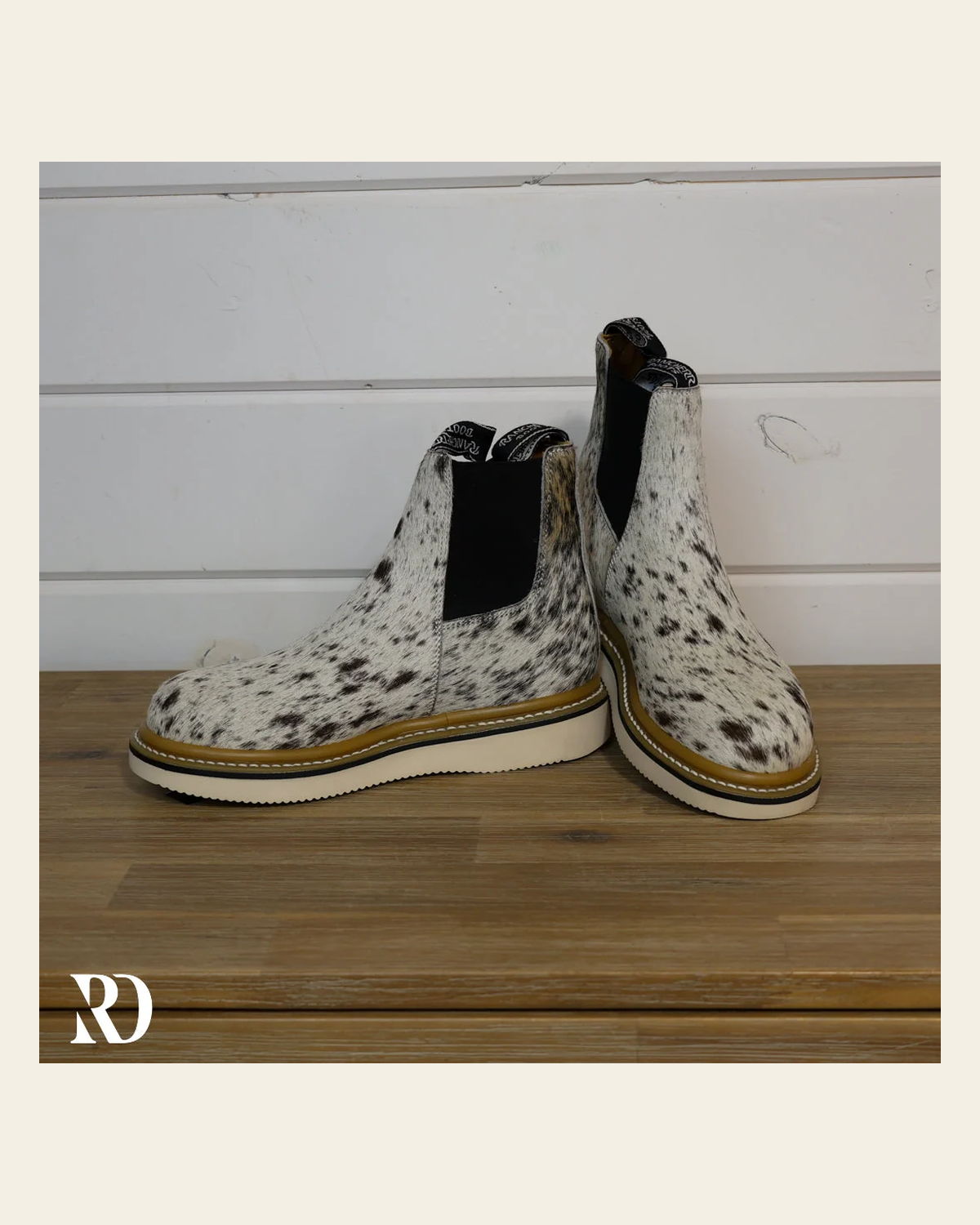 Size 7.5 (style #193) | Hair On Hide Lechera Boot on a warm cream background