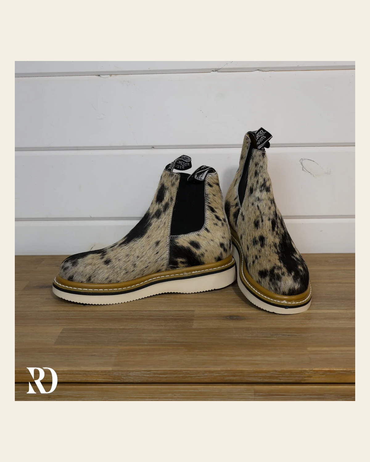 Size 7.5 (style #194) | Hair On Hide Lechera Boot on a warm cream background