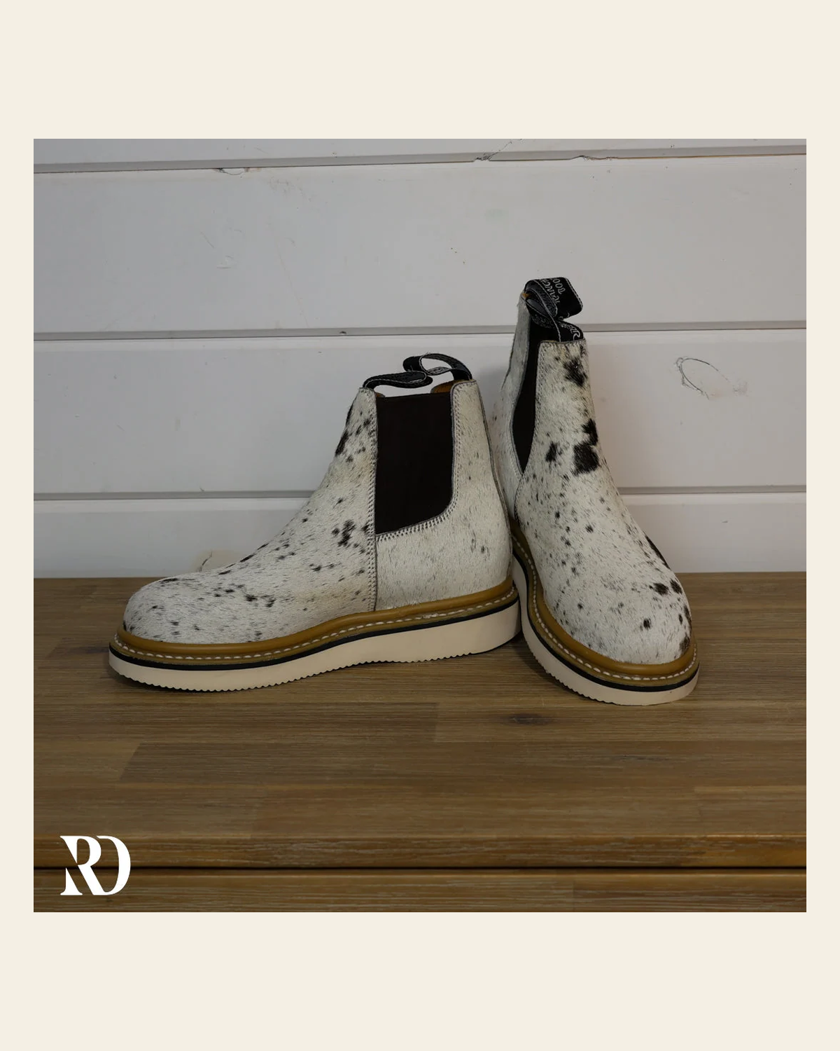 Size 7.5 (style #195) | Hair On Hide Lechera Boot on a warm cream background