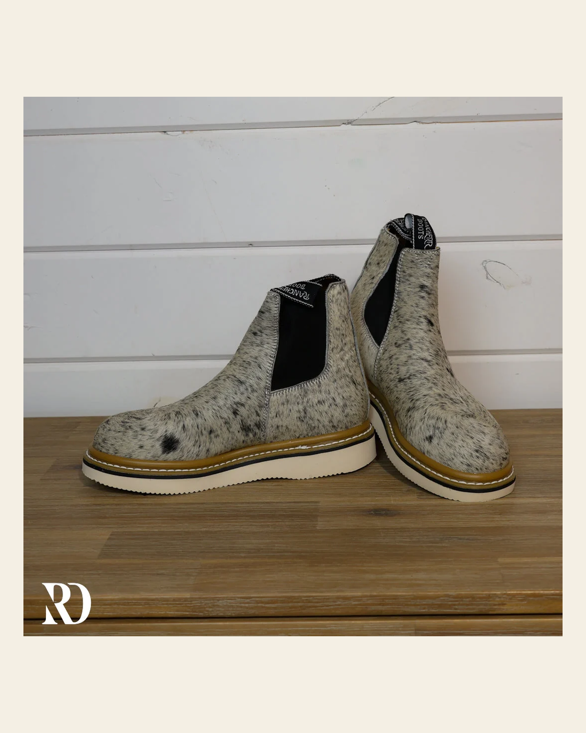 Size 7.5 (style #199) | Hair On Hide Lechera Boot on a warm cream background