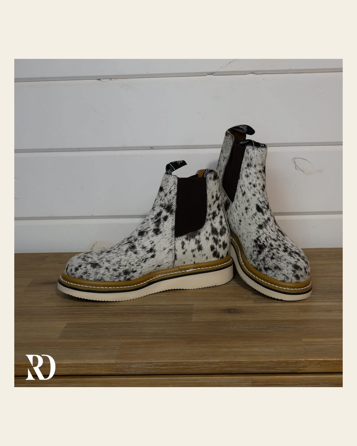 Size 7.5 (style #200) | Hair On Hide Lechera Boot on a warm cream background