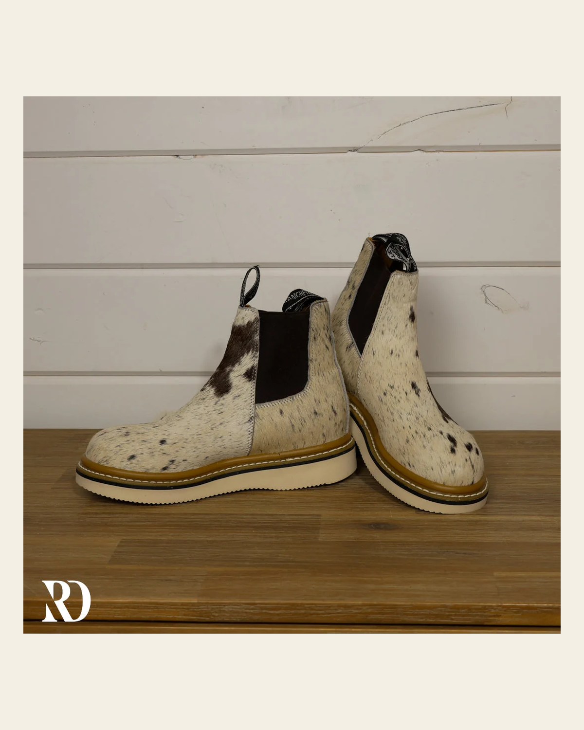 Size 7.5 (style #288) | Hair On Hide Lechera Boot on a warm cream background