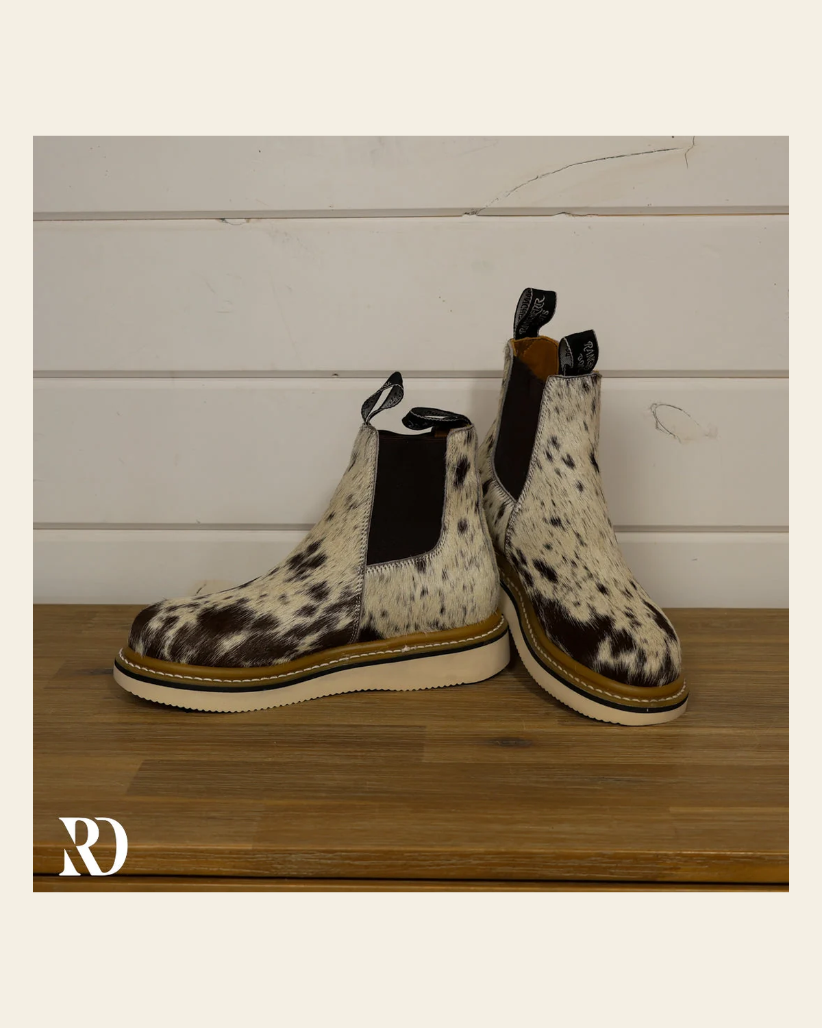 Size 7.5 (style #297) | Hair On Hide Lechera Boot on a warm cream background