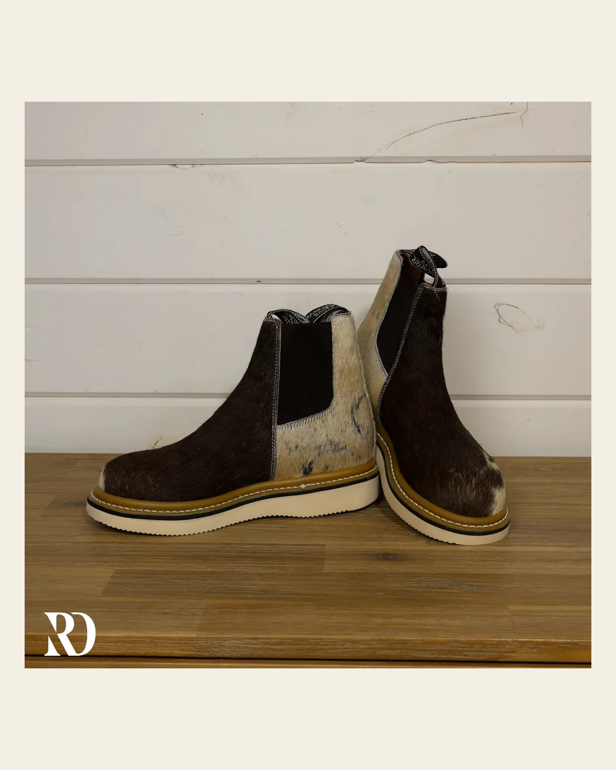 Size 7.5 (style #298) | Hair On Hide Lechera Boot on a warm cream background