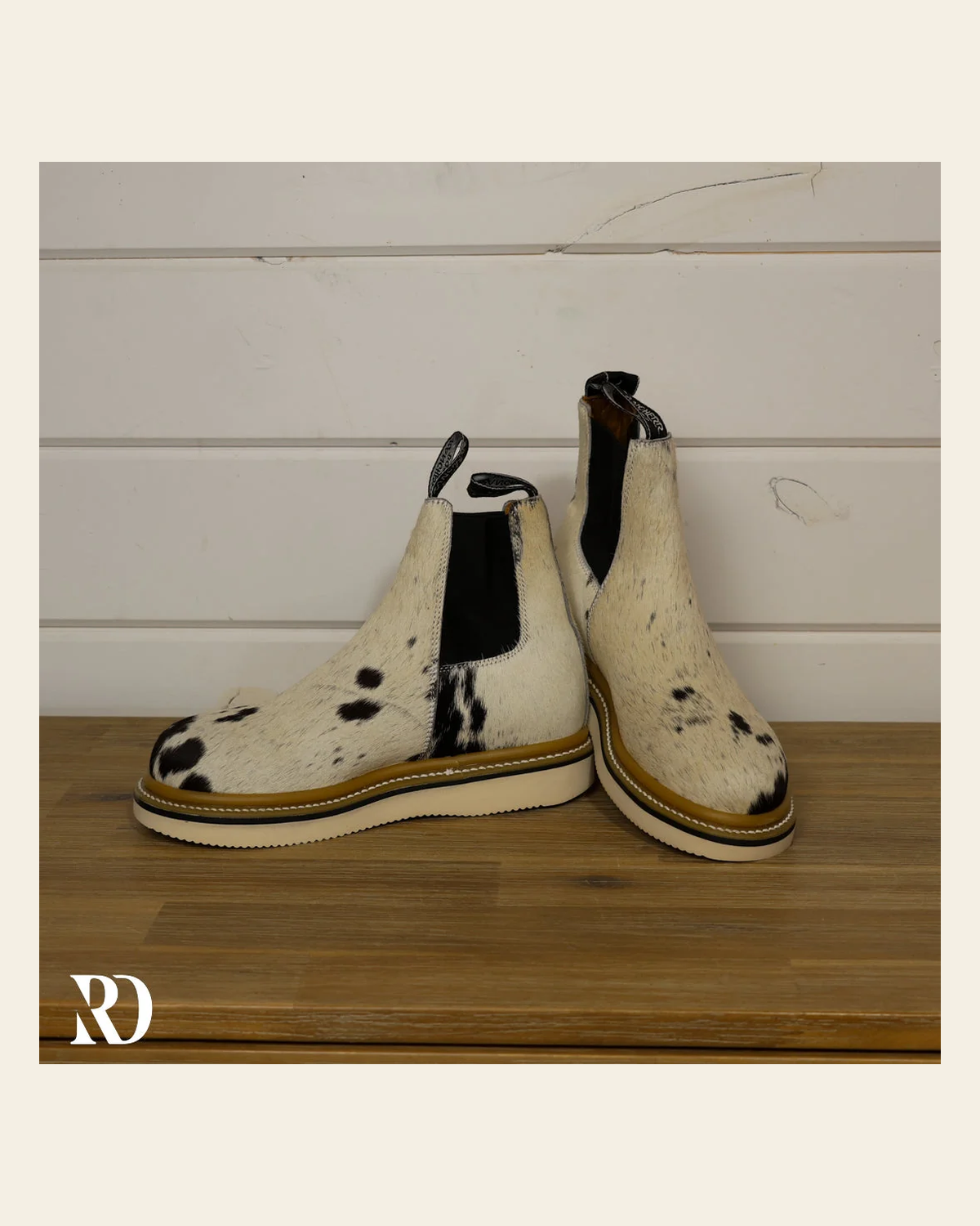 Size 7.5 (style #306) | Hair On Hide Lechera Boot on a warm cream background