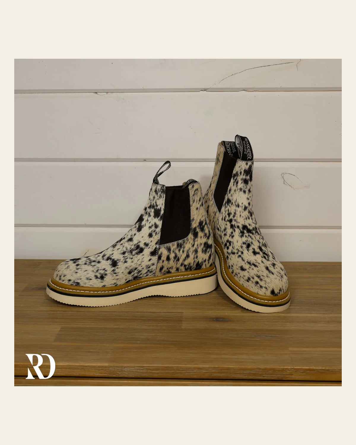Size 7.5 (style #307) | Hair On Hide Lechera Boot on a warm cream background