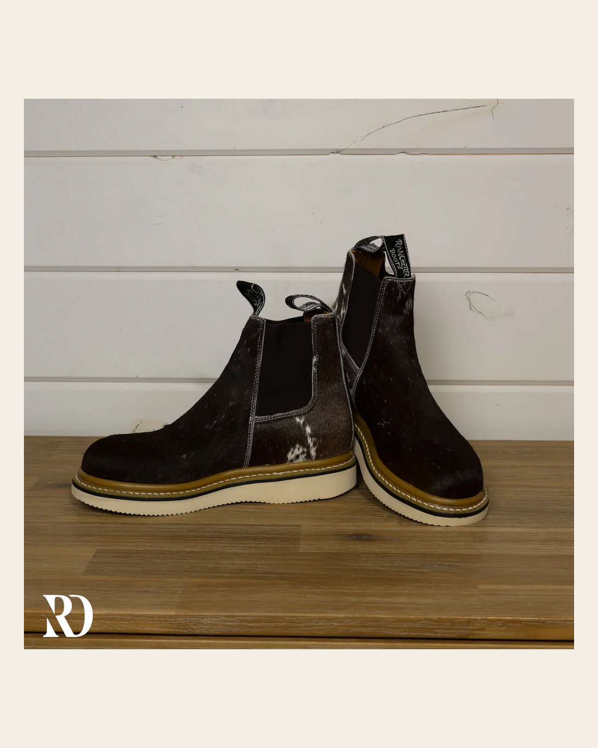 Size 7.5 (style #308) | Hair On Hide Lechera Boot on a warm cream background