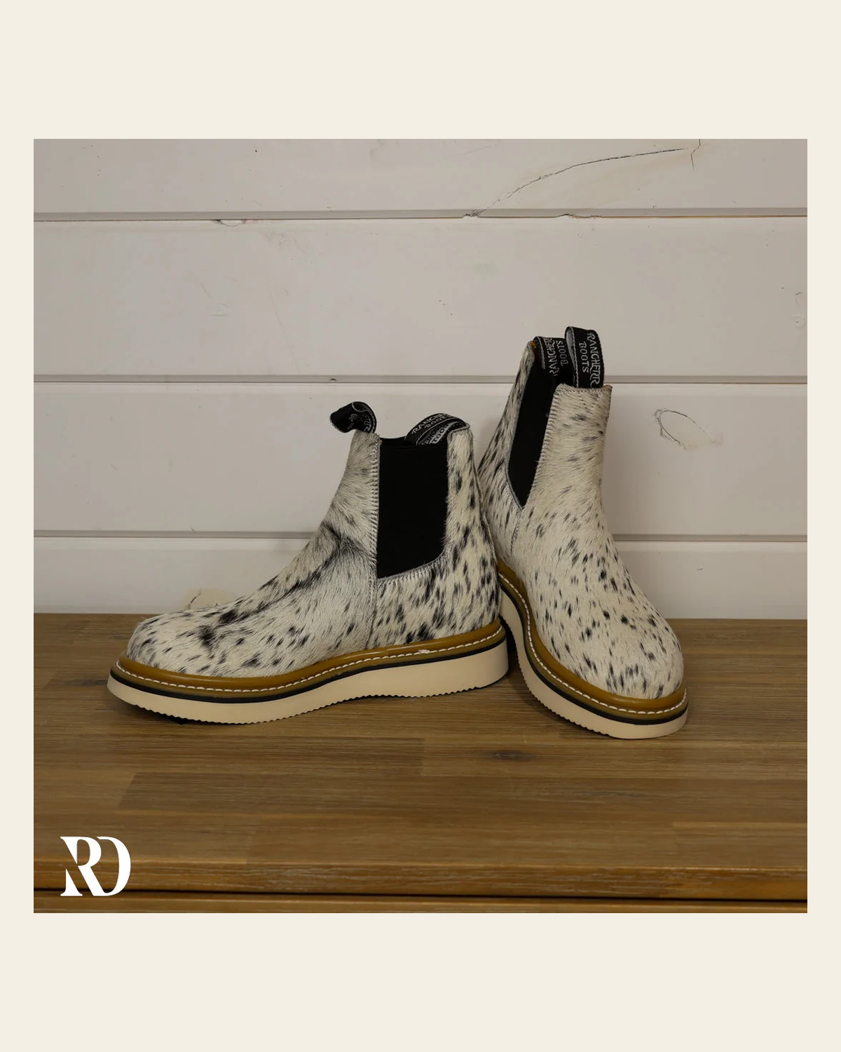 Size 7.5 (style #312) | Hair On Hide Lechera Boot on a warm cream background