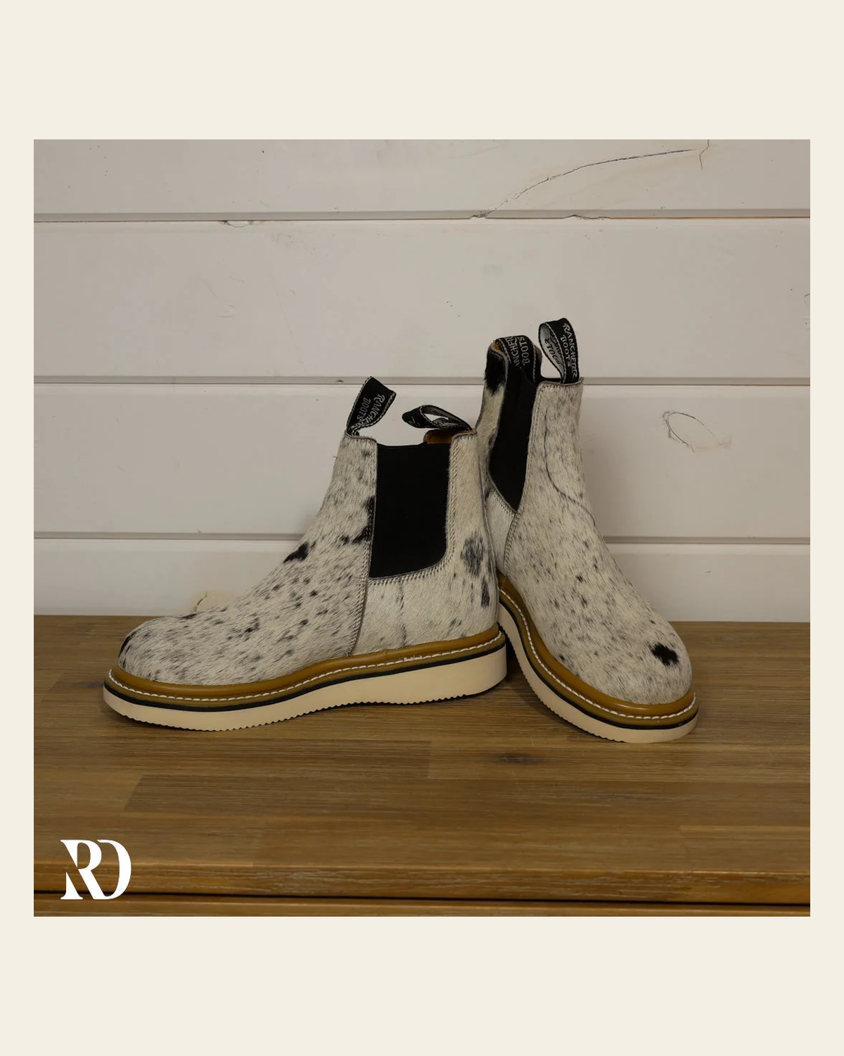 Size 7.5 (style #314) | Hair On Hide Lechera Boot on a warm cream background