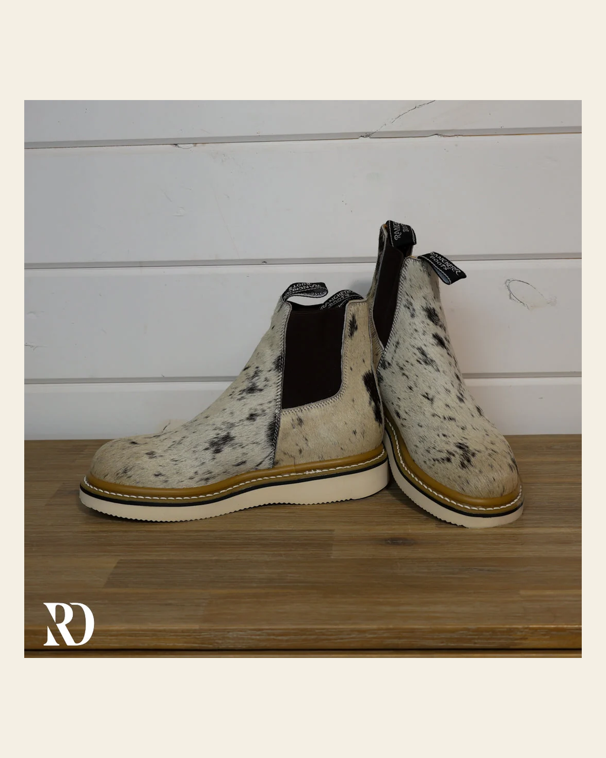 Size 8.5 (style #211) | Hair On Hide Lechera Boot on a warm cream background
