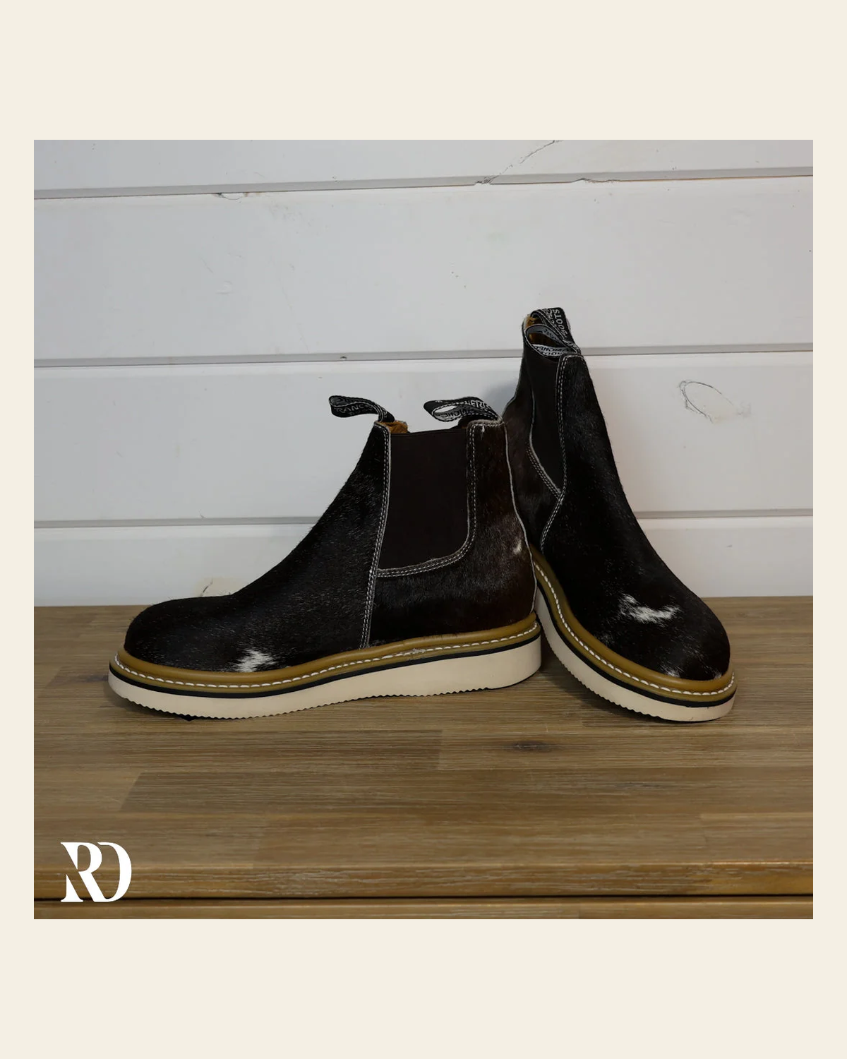 Size 8.5 (style #218) | Hair On Hide Lechera Boot on a warm cream background