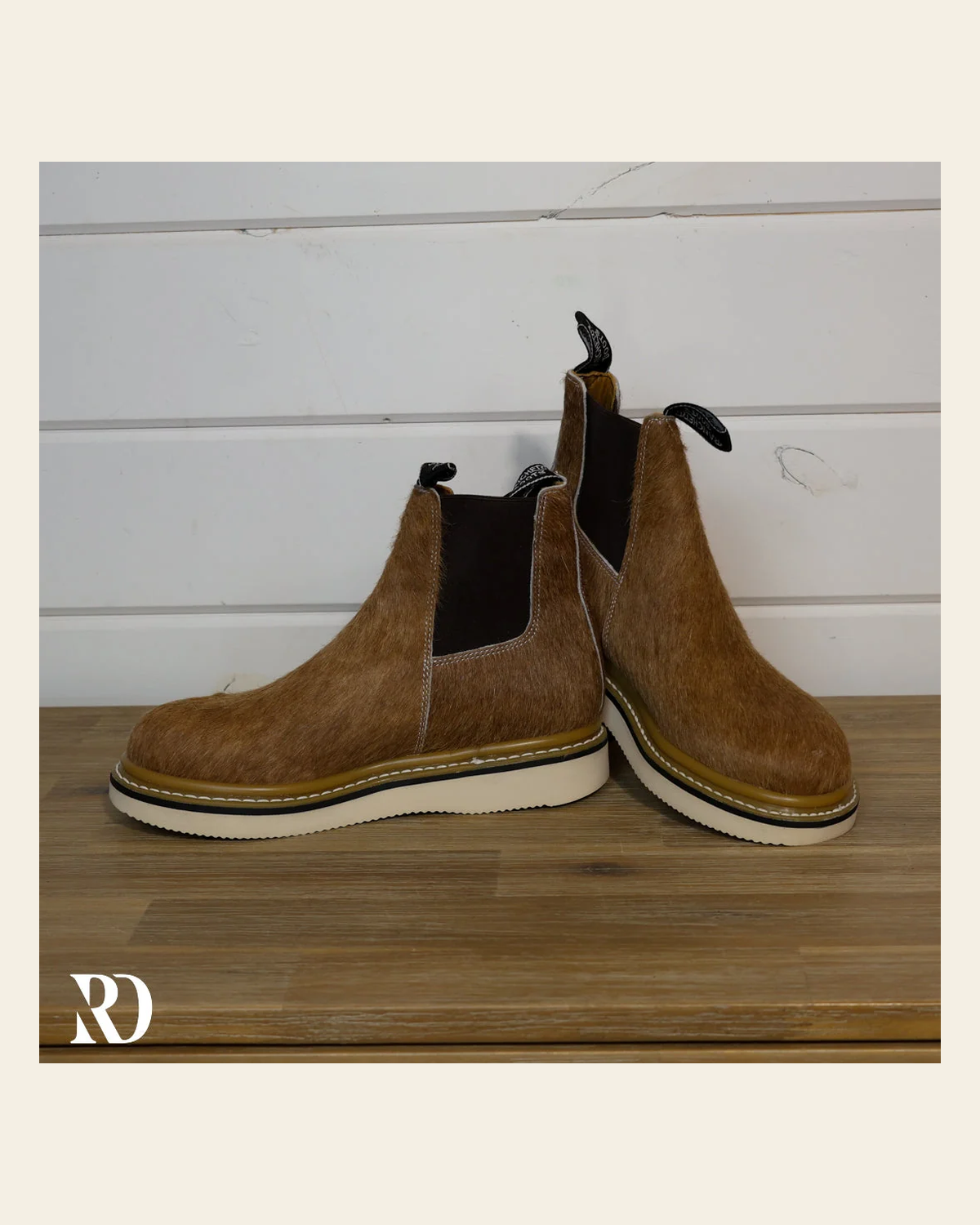 Size 8.5 (style #220) | Hair On Hide Lechera Boot on a warm cream background