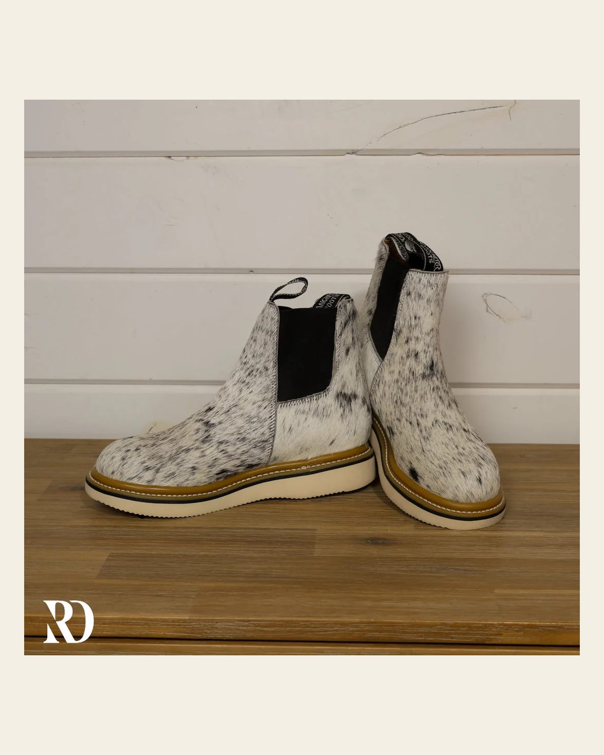 Size 8.5 (style #332) | Hair On Hide Lechera Boot on a warm cream background