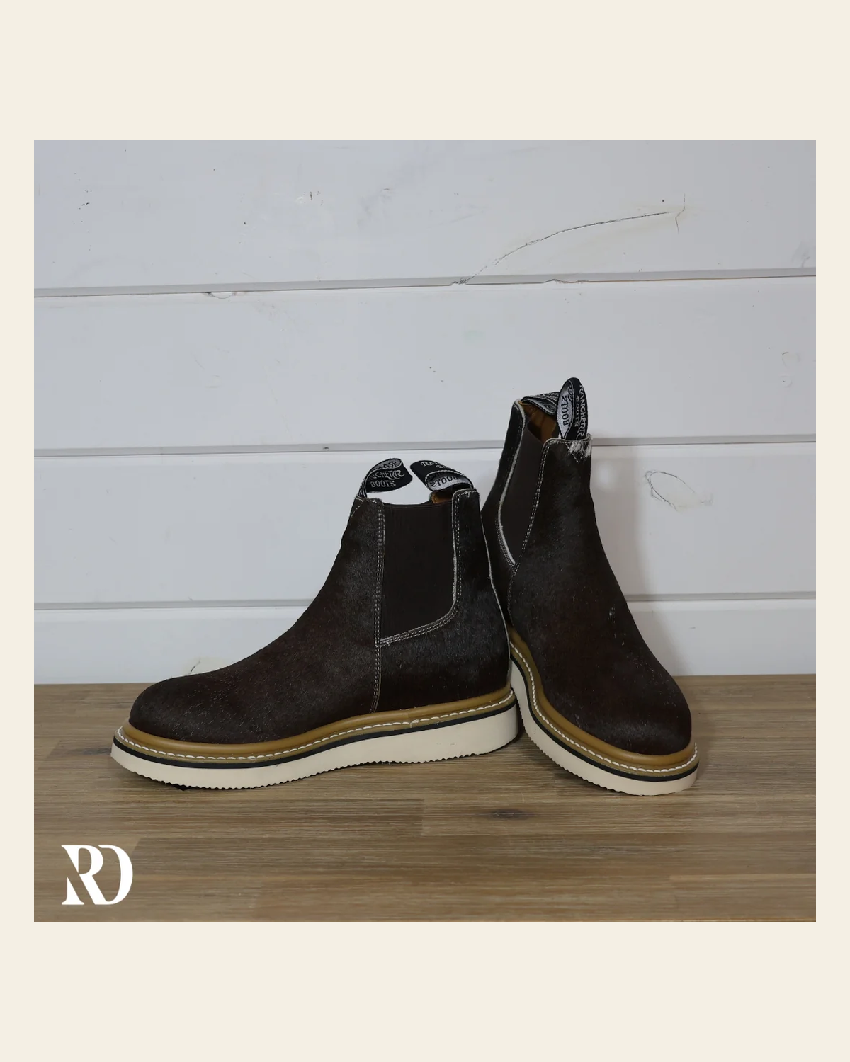 Size 8.5 (style #419) | Hair On Hide Lechera Boot on a warm cream background