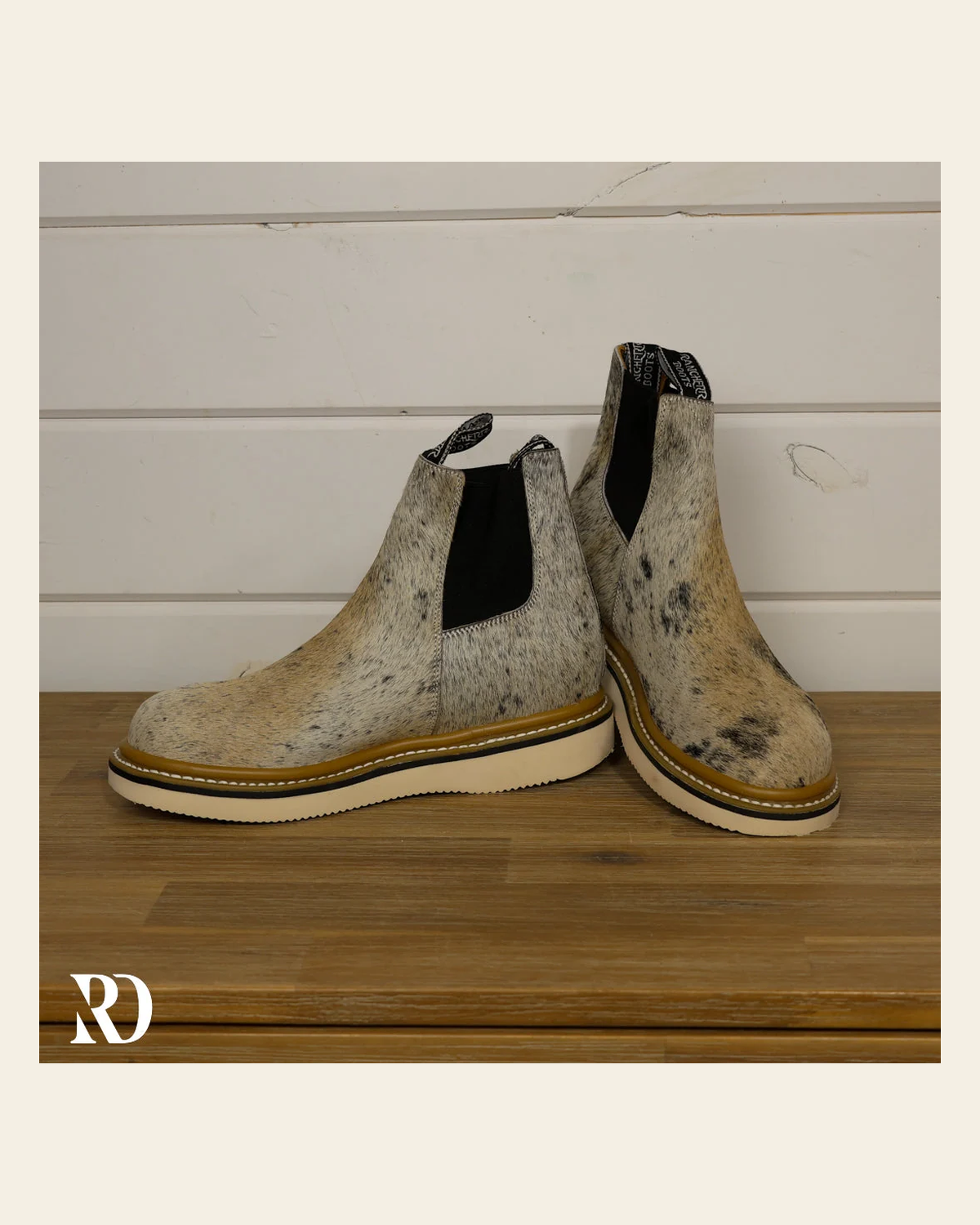 Size 9.5 (style #250) | Hair On Hide Lechera Boot on a warm cream background