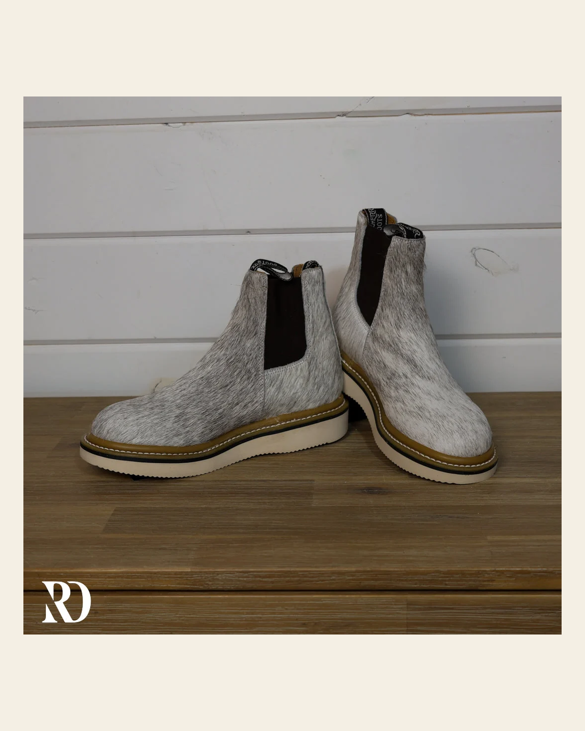 Size 7.5 (style #113) | Hair On Hide Lechera Boot on a warm cream background