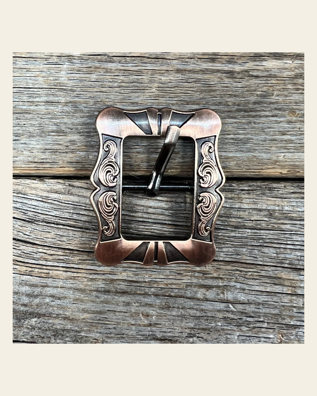 Small Copper Cart Buckle W158B on a warm cream background