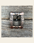 Small Copper Cart Buckle W158B on a warm cream background