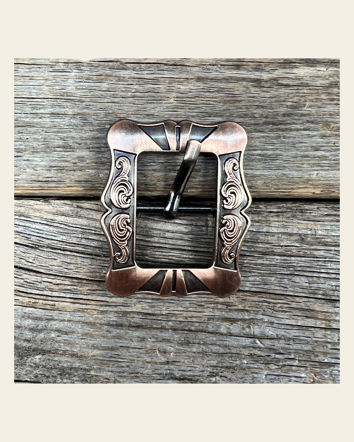 Small Copper Cart Buckle W158B on a warm cream background