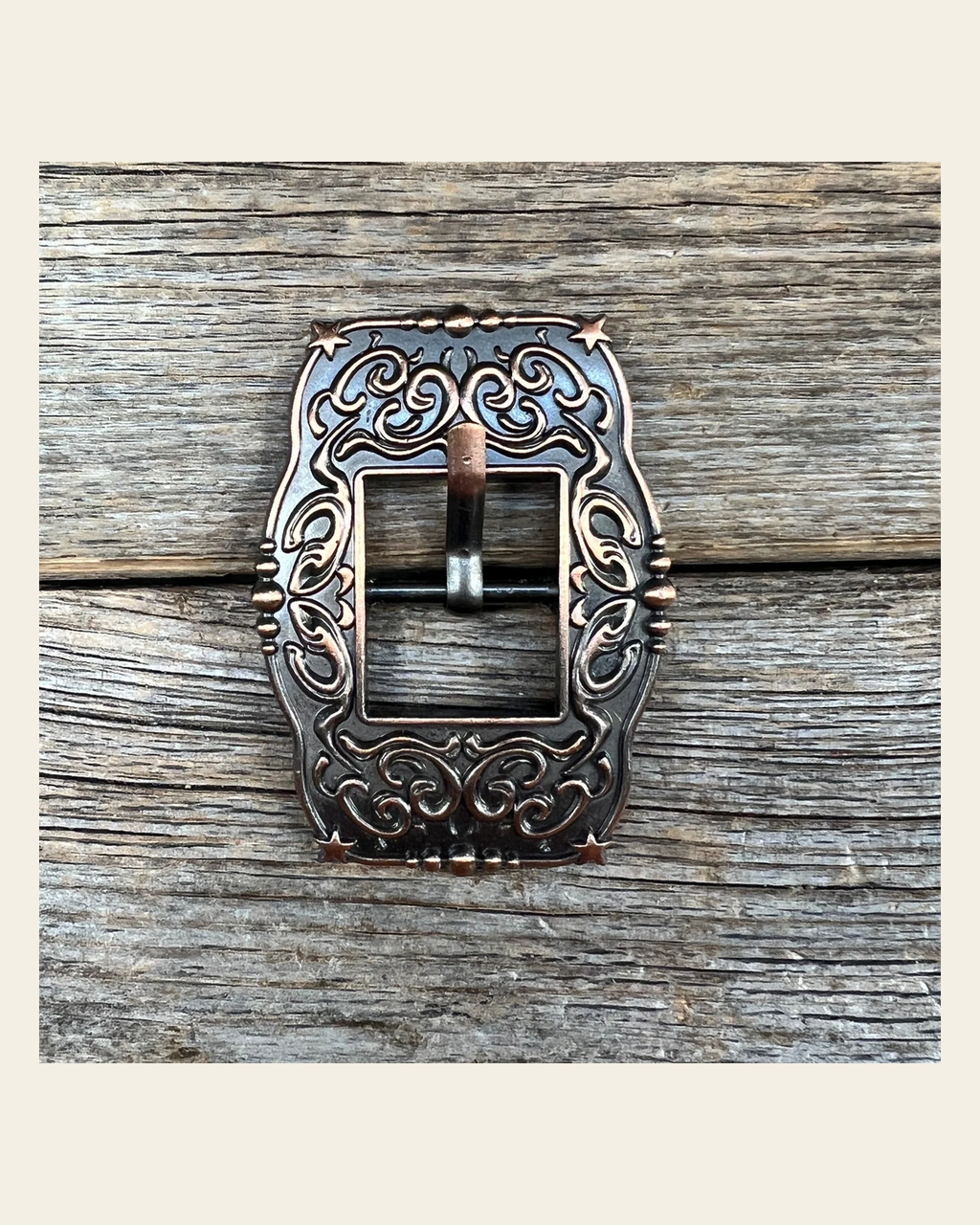 Small Star Copper Cart Buckle W176B on a warm cream background