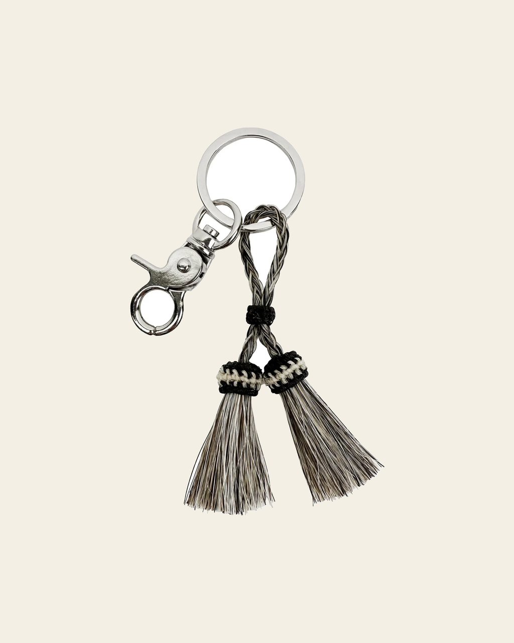 Smoke Hitched Horsehair Double Tassel Keychain on a warm cream background