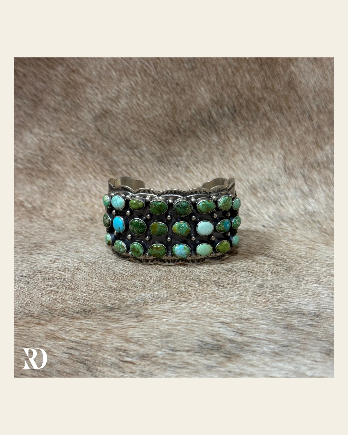 Sonoran Gold Multi-stone Turquoise Cuff By Tom Lewis on a warm cream background