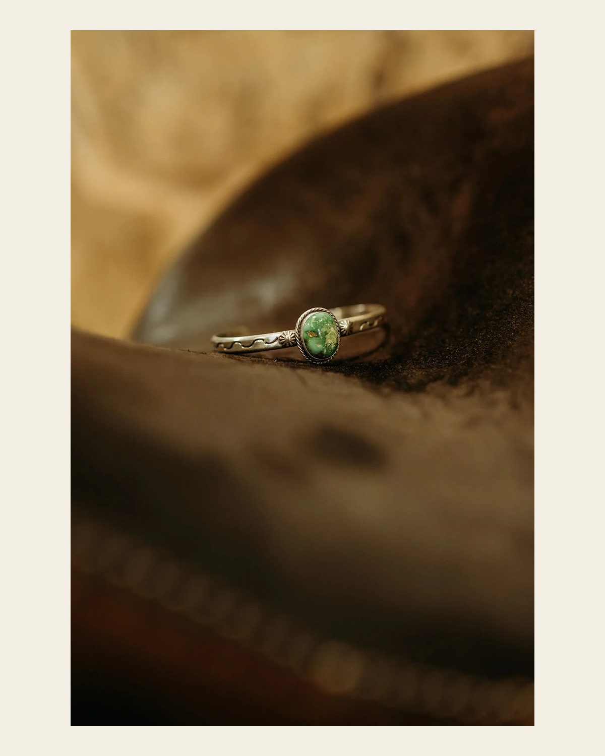Sonoran Gold Turquoise Cuff By Sam Yellowhair on a warm cream background