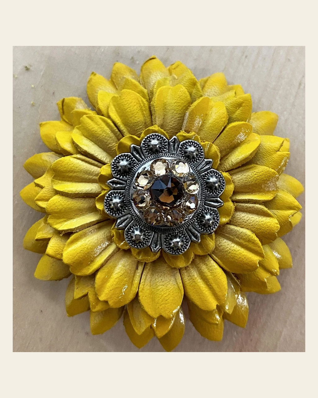 Sunflower With Antique Silver Topaz & Champagne 1" Concho on a warm cream background